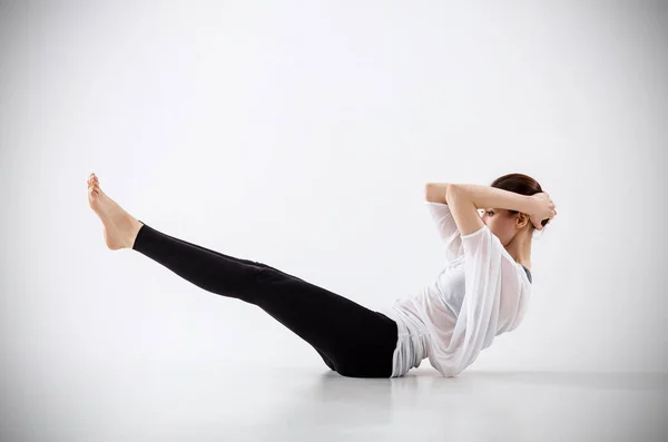 Young woman doing yoga exercise on the floor. — Stock Photo, Image