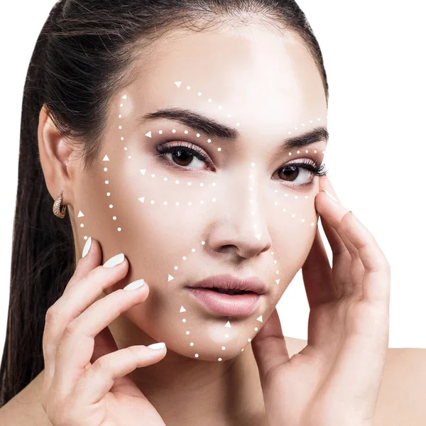 Massage lines on female face with vitiligo show directions. — ストック写真