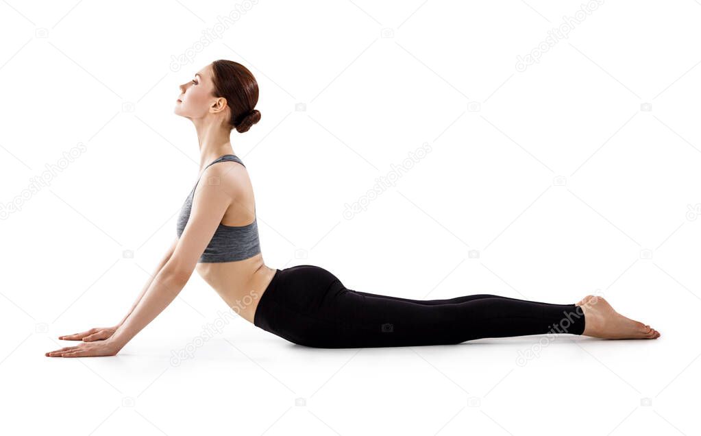 Attractive young woman practicing yoga.