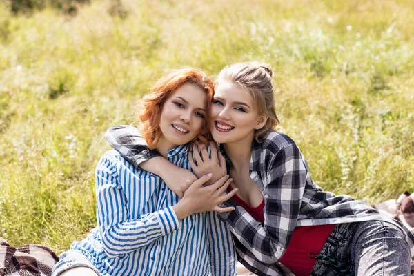 Young beautiful women on picnic in summer park.