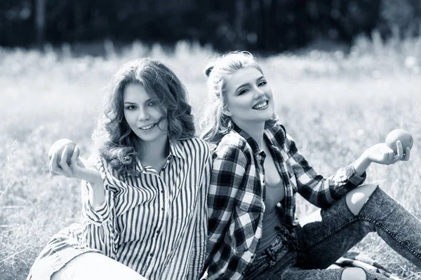 Young beautiful women on picnic in summer park.