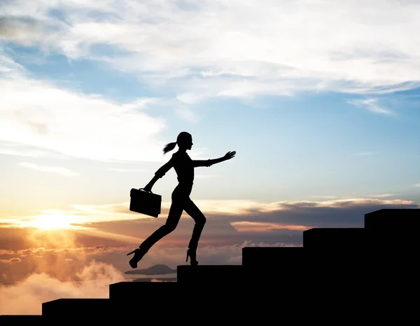 Silhouette of woman rise up on stairs from business word. — Stock Photo, Image