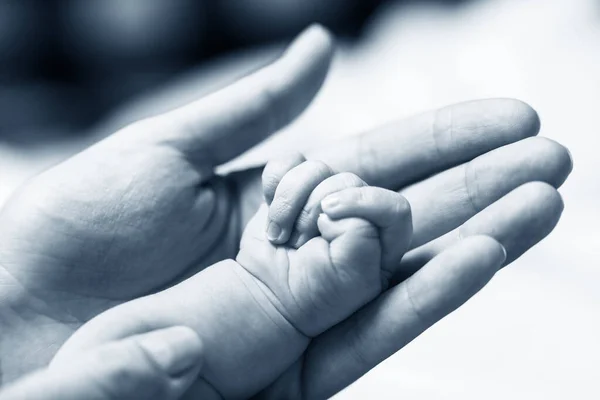 Mujer mano sosteniendo recién nacido babys mano . — Foto de Stock