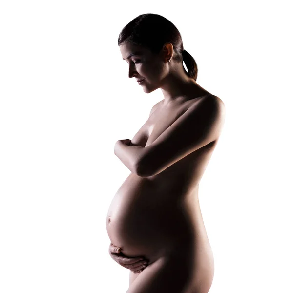 Nackte schwangere Frau mit einem riesigen schönen Bauch. — Stockfoto