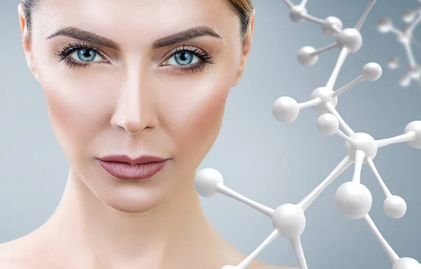 Strict woman with big white molecule chain. — Stock Photo, Image