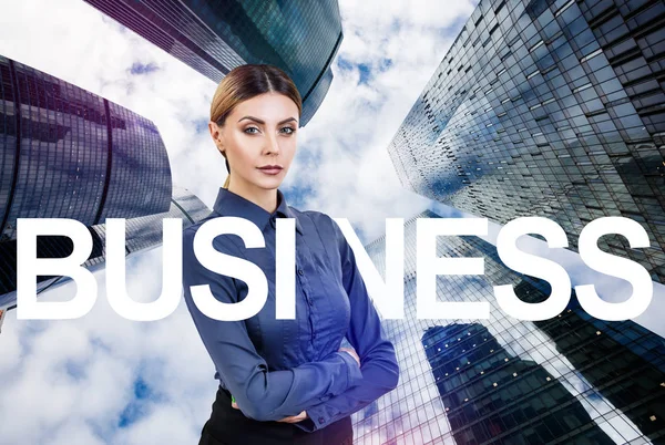 Business woman among big letters of tag word BUSINESS. — Stock Photo, Image