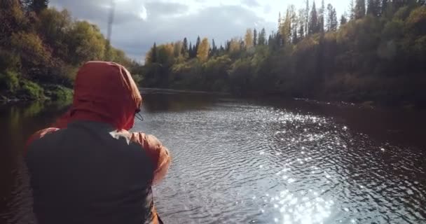 Vista trasera del pescador lanza un caño de pescar en el río . — Vídeos de Stock