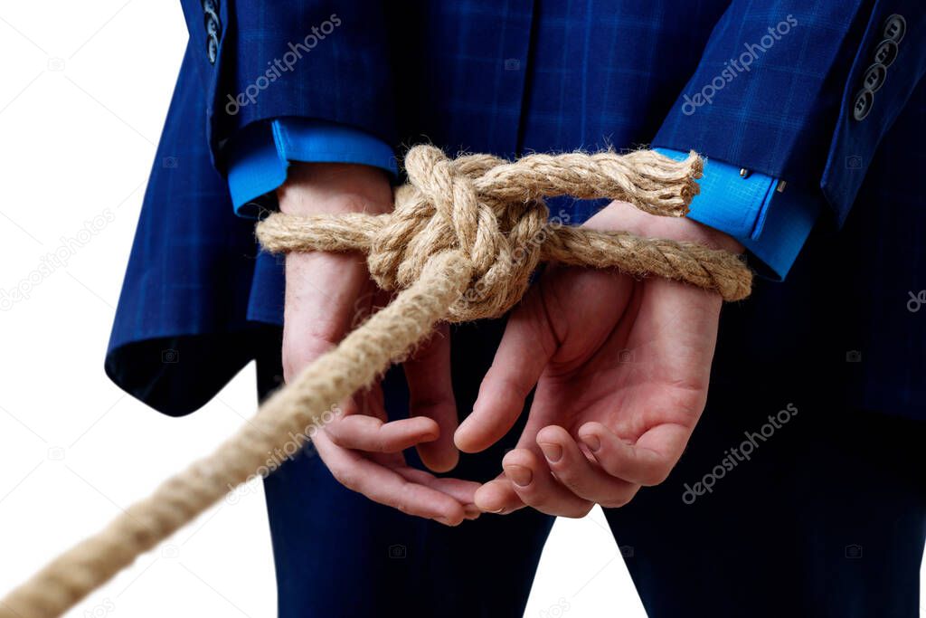 Close-up view on tied hands of businessman in blue suit.