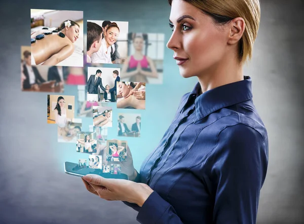 Business woman looks on images with her different hobbies. — Stock Photo, Image