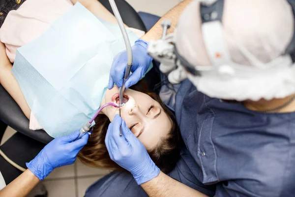 Dentista tratamento de dentes para jovem paciente na clínica . — Fotografia de Stock