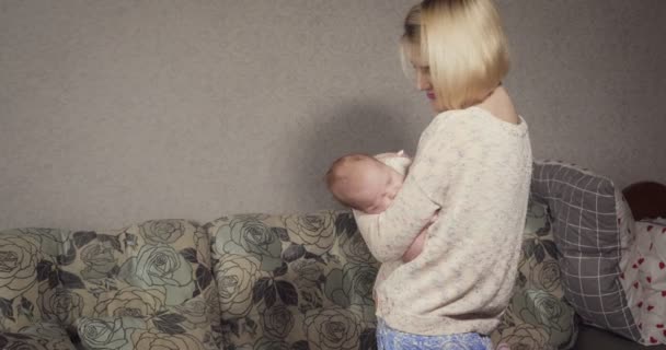 Η νεαρή μητέρα βάζει το μωρό της για ύπνο.. — Αρχείο Βίντεο