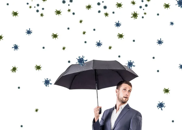 Coronavirüs hücreleri arasında şemsiye altında genç iş adamı. — Stok fotoğraf