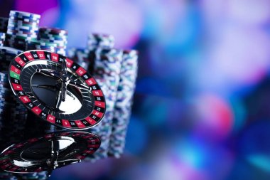 Casino Tema. Casino rulet ve poker chipi tüm renkli bokeh arka plan üzerinde bir oyun Masa üzerinde yüksek kontrast görüntü. Tipografi ve logo için yer.