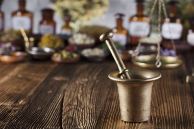 Doğal Tıp arka plan. Pirinç harç, ölçek. Rustik tablo. Çeşitli kuru otlar kase. Bokeh.