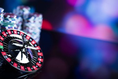 Casino Tema. Casino rulet ve poker chipi tüm renkli bokeh arka plan üzerinde bir oyun Masa üzerinde yüksek kontrast görüntü. 