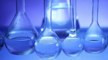 Modern Laboratuar donanımları, üzerinde mavi arka plan farklı cam ayarlayın. Dolly vurdu.