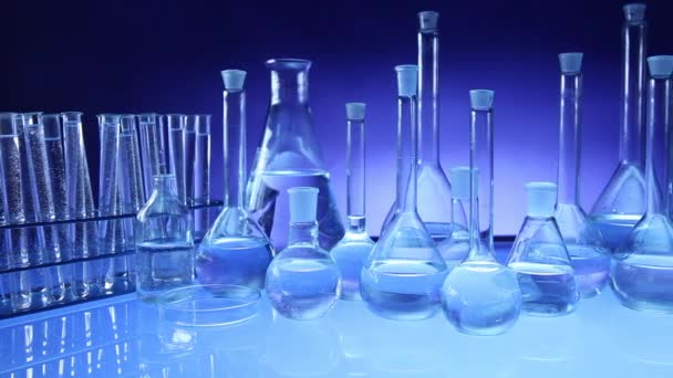 现代实验室设备 在蓝色背景上设置不同的玻璃器皿 多莉射击 — 图库视频影像