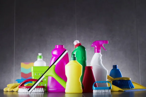 Colorful set of home cleaning products on the gray tiles.  Place for typography.