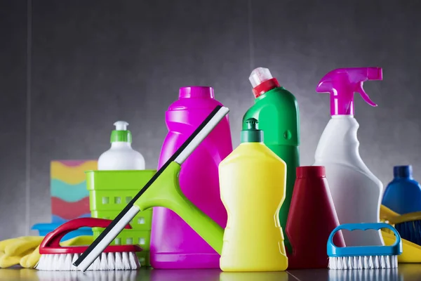 Colorful set of home cleaning products on the gray tiles.  Place for typography.