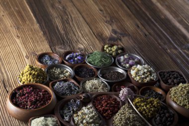 Alternatif Tıp. Ahşap rustik masa üzerinde kaseler, harç ve tıp şişelerde otlar.