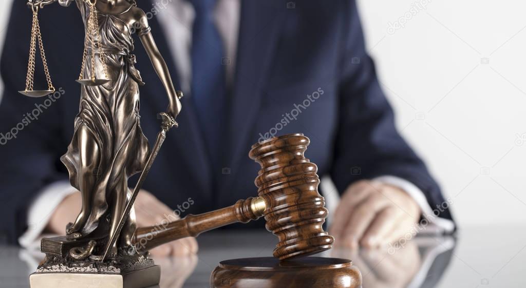  Legal counsellor. Mallet and Themis statue on white table and background.