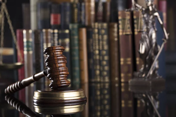 Law code. Statue of justice, gavel and  books. Brown background. Place for text.