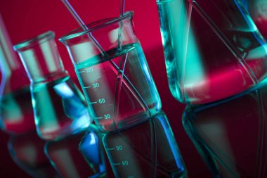 Kimyasal laboratuvar kavramı. Sıvı ile denemeler yapın. Kırmızı arka plan. Logo için yer.