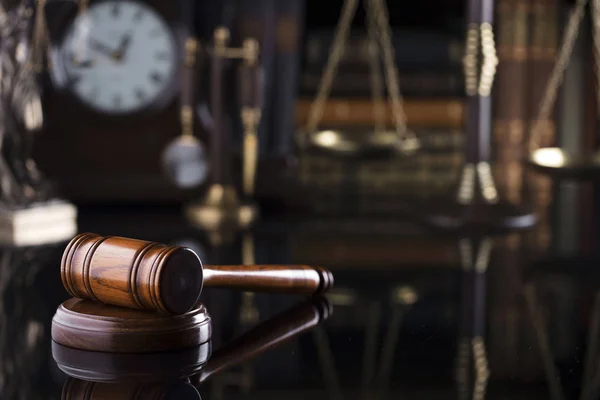 Law firm concept. Gavel, clock, books, balance. Brown background.