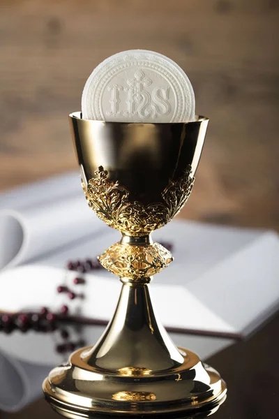 最初の聖体拝領のテーマ 聖書と茶色の背景に黄金の杯 — ストック写真