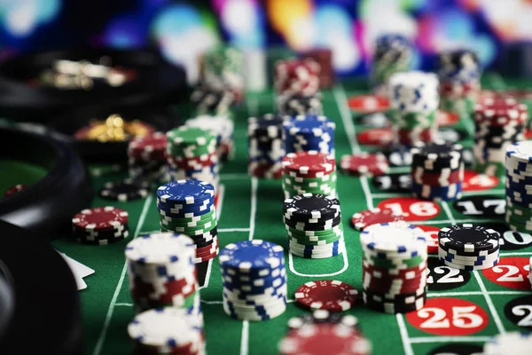 Stack of casino chips on green felt poker table