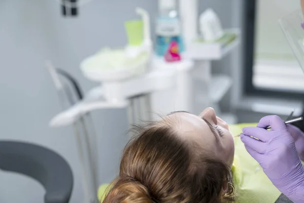 Dental practice.  Dentist examing female patient in dental clinic. Modern medical equipment.