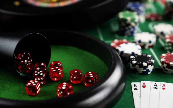 Roulette table in casino. Casino felt green table with red and black numbers. Stack of poker chips.