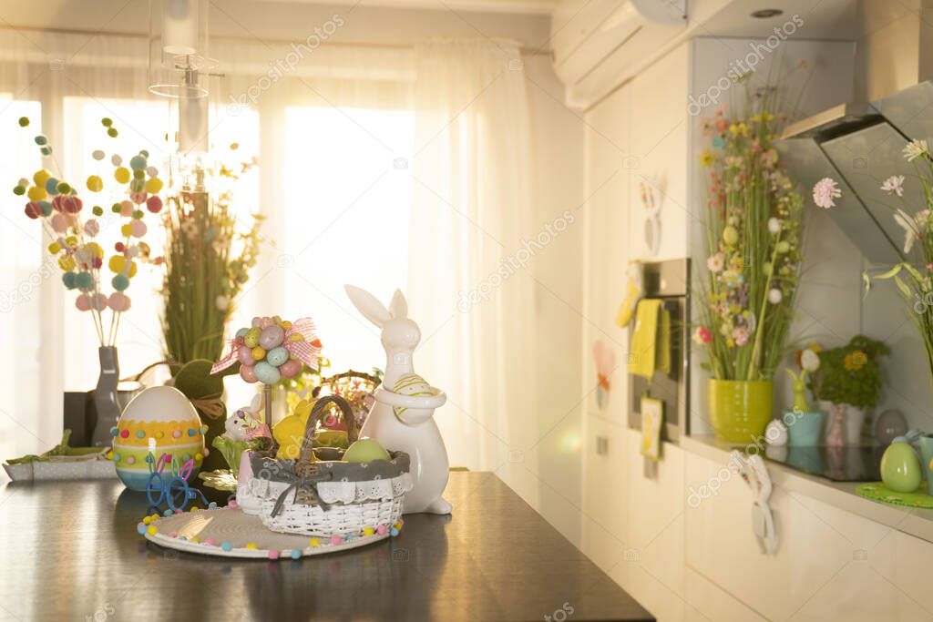 Easter theme. Easter decorations. Easter eggs in basket and easter bunnies. Bouquet of spring flowers.