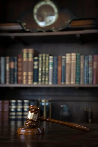 法官办公室 在褐色的发光桌子上的伽弗尔和书架上的法律汇编 — 图库照片