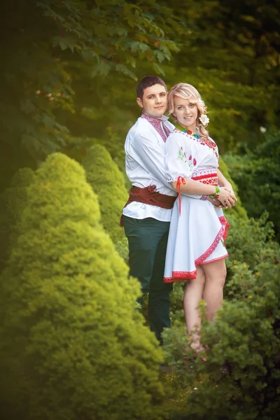 Novia y novio en el día de la boda caminando al aire libre en la naturaleza de primavera. Pareja nupcial, feliz mujer recién casada y hombre abrazándose en el parque verde. Amar pareja de boda al aire libre . —  Fotos de Stock