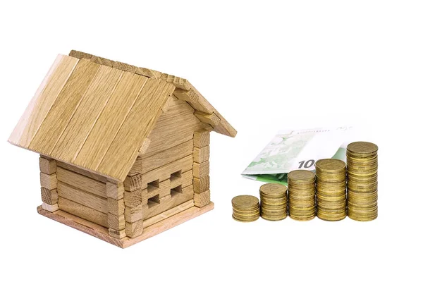 Wooden house block with coins. (finance, property and house loan Stock Photo