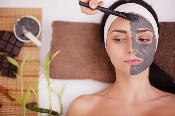 Young woman in beauty salon having face mask — Stock Photo, Image