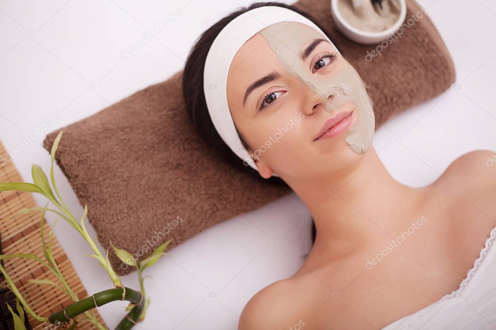 Masseur doing massage the head of an Asian woman in the spa salon