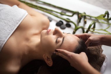 Cilt ve vücut bakımı. Yakın çekim Spa muamele güzellik salonunda genç bir kadın. Spa yüz masaj. Yüz güzellik bakımı. Spa Salonu.