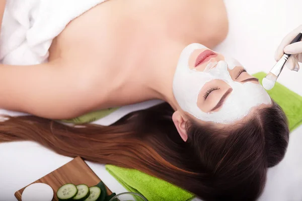 Concetto Spa. Mano applicare maschera nutriente sul viso femminile nel salone spa — Foto Stock