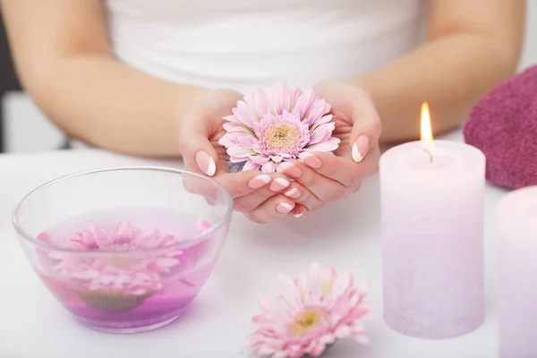 Woman hands receiving a hand scrub peeling by a beautician in be