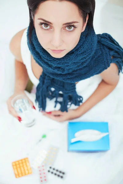 Sick beautiful woman resting in bed at home Royalty Free Stock Photos