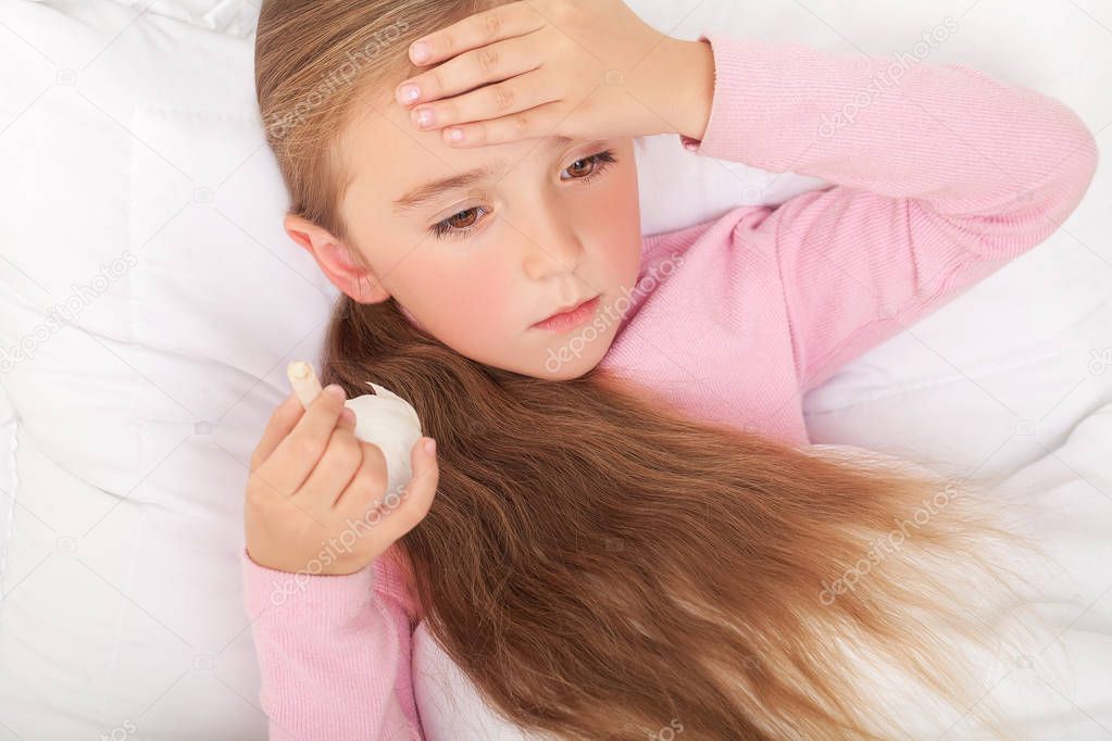 Sick Girl On Bed Sneezing In Handkerchief In Bedroom