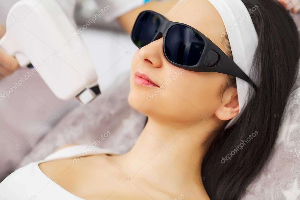 Laser epilation and cosmetology.at cosmetic beauty spa clinic. Hair removal cosmetology procedure from a therapist. Cosmetology and SPA concept.