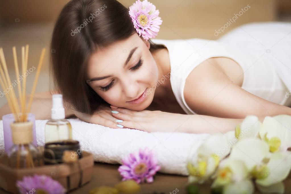 Spa. Women's health. Portrait of a beautiful smiling woman with a fresh face. Soft skin. A healthy happy girl with a natural makeup that relaxes indoors. Beauty, concept of skin care. Spas.