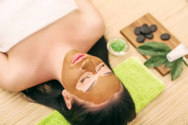 Spa Mask. Woman in Spa Salon. Face Mask. Facial Clay Mask.