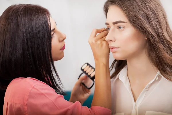 Akeup sanatçı m çekici esmer kız makyaj uygulandığı — Stok fotoğraf