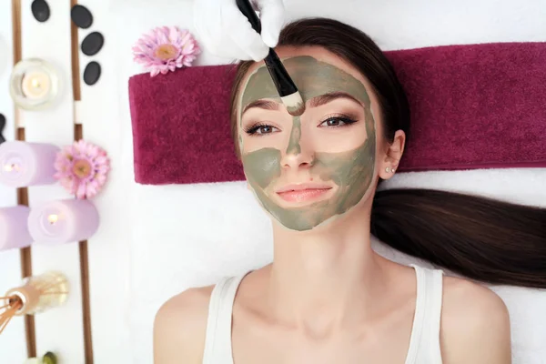 Tratamiento de belleza facial. Hermosa mujer consiguiendo máscara cosmética — Foto de Stock