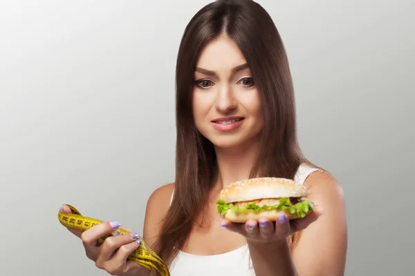 Harmful food. A young girl is struggling with overweight and mal — Stock Photo, Image