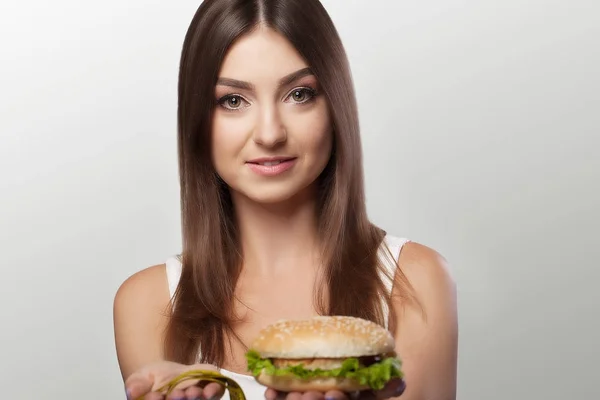 Hands offer an apple (healthy food) and cakes (unhealthy food) t — Stock Photo, Image